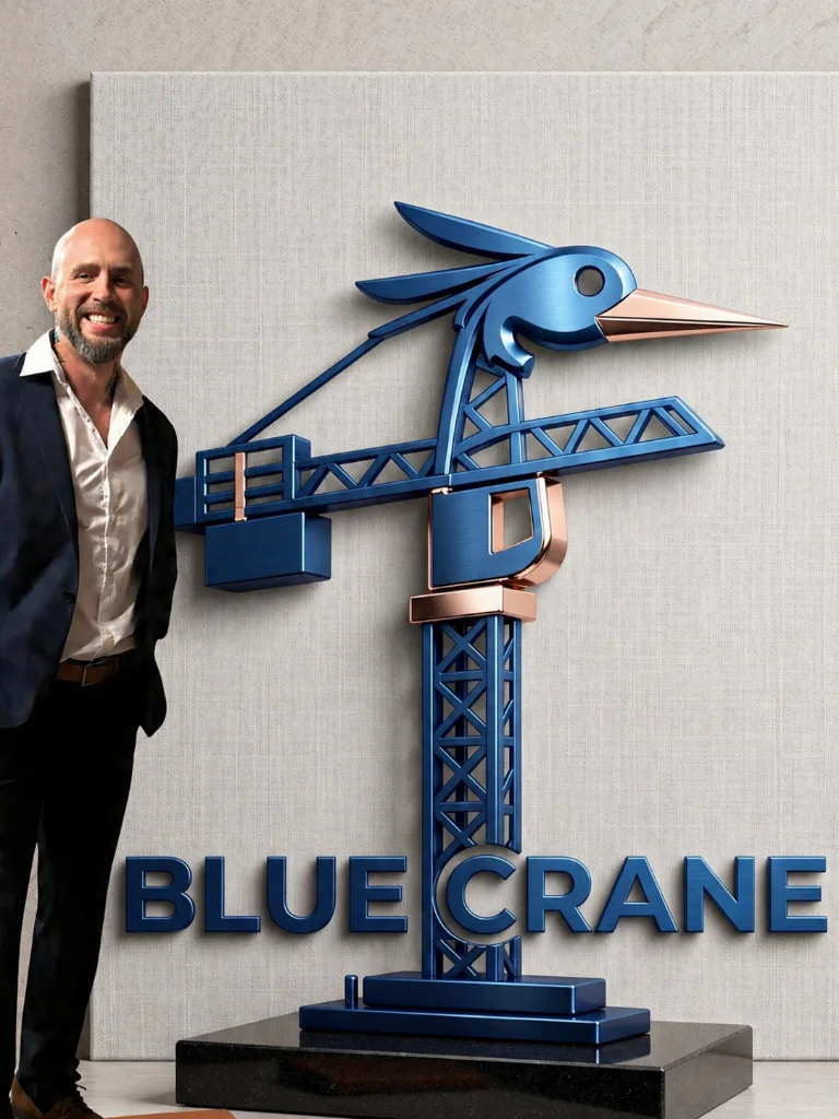 Trevor, founder of Blue Crane and a millwright in Hamilton, Ontario, beside the Blue Crane sculpture